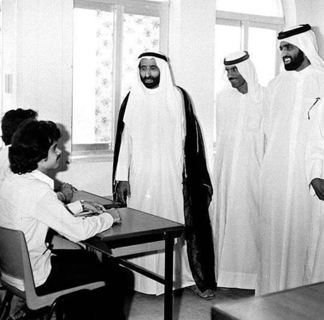 Archival photograph of a school visit by dignitaries to a Ras Al Khaimah classroom